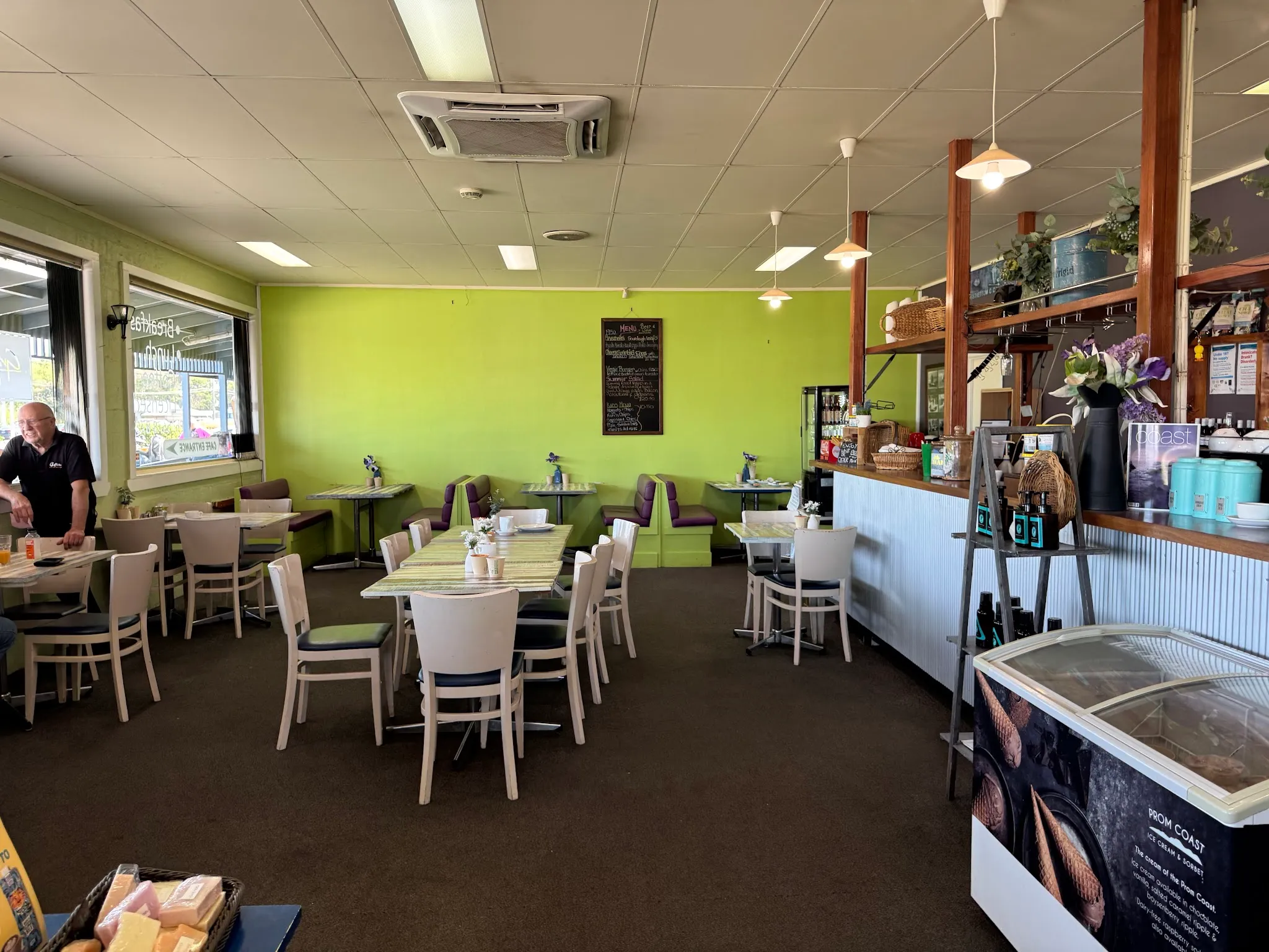Grantville Bakehouse dine-in cafe room with white chairs and lime green walls