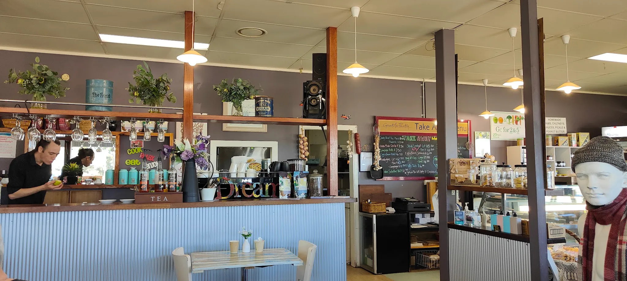 Grantville Bakehouse cafe counter with hanging plants, chalkboard menu and corrugated iron details