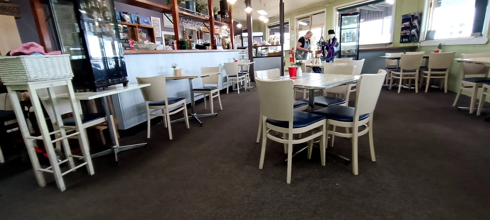 Grantville Bakehouse dining room interior with white tables, corrugated iron wall and staff at counter